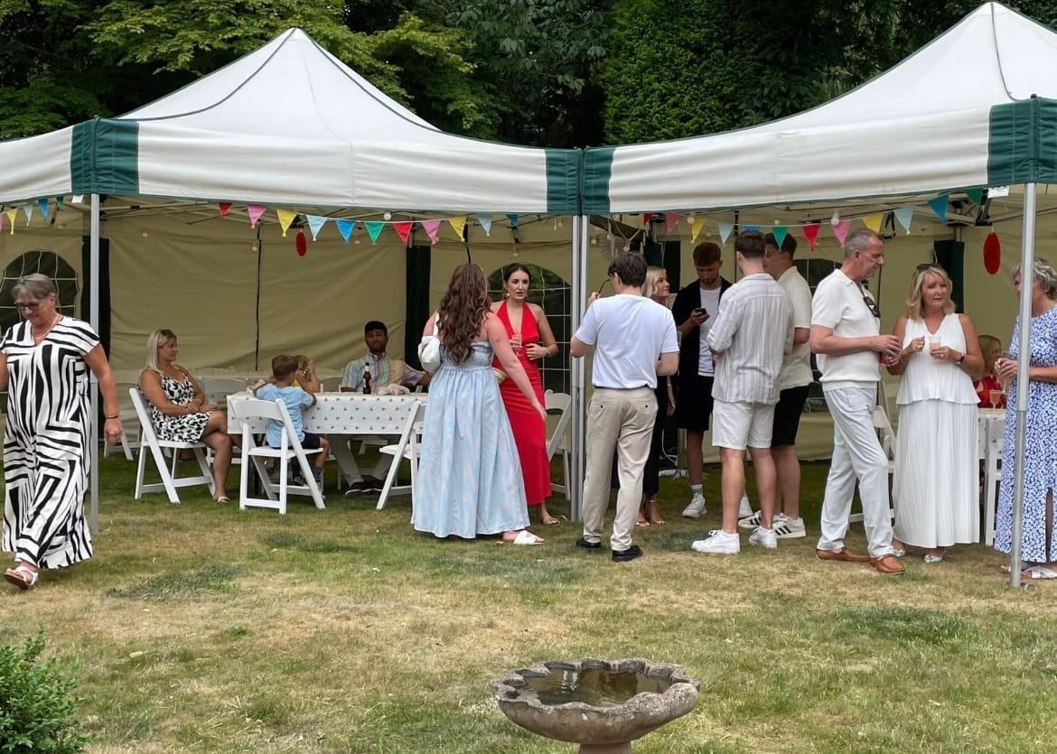 Two linked hexagonal 6m x 6m mini marquees at a Mansfield event with guests socialising
