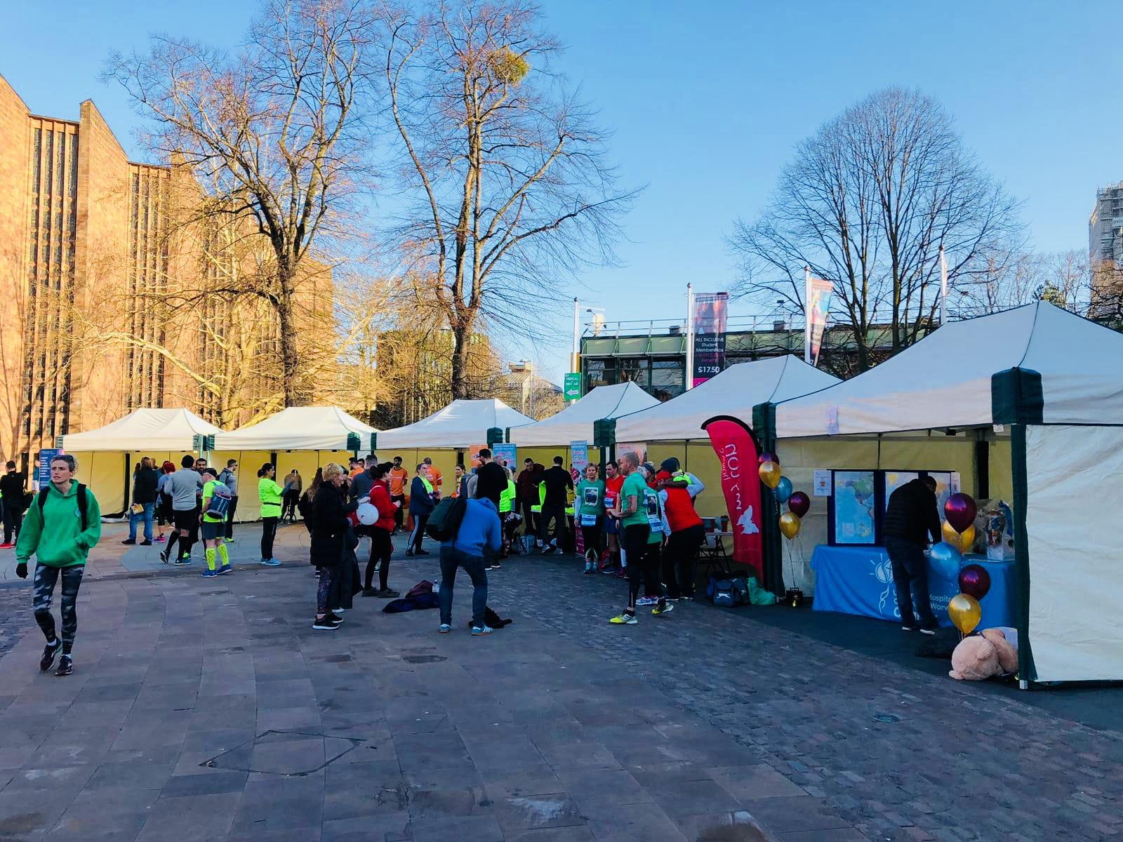 Six linked 3m × 4.5m mini marquees at a Coventry University charity running event with participants